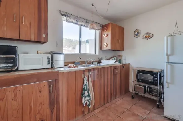 a kitchen with sink cabinets and window