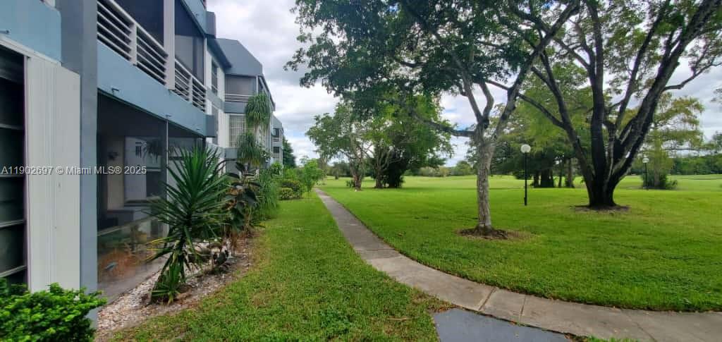 8331 Sands Point Boulevard, Unit C205 Tamarac, FL 33321 - Photo 13 of 25 a view of a park with a tree