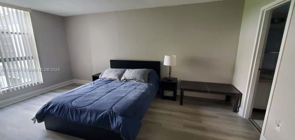 8331 Sands Point Boulevard, Unit C205 Tamarac, FL 33321 - Photo 16 of 25 a bedroom with a bed and window