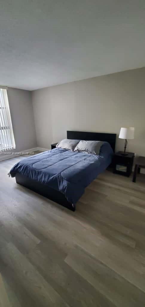 8331 Sands Point Boulevard, Unit C205 Tamarac, FL 33321 - Photo 18 of 25 a bedroom with a bed and a lamp on desk