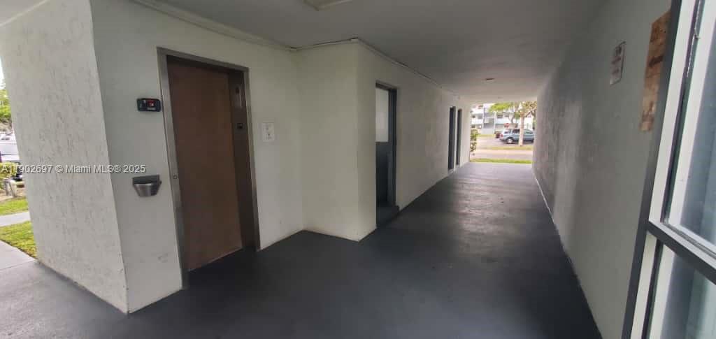 8331 Sands Point Boulevard, Unit C205 Tamarac, FL 33321 - Photo 23 of 25 an entryway with a hallway to a room