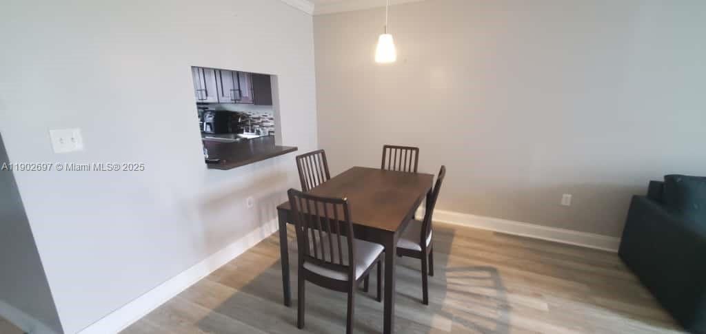 8331 Sands Point Boulevard, Unit C205 Tamarac, FL 33321 - Photo 6 of 25 a view of a dining room with furniture and wooden floor