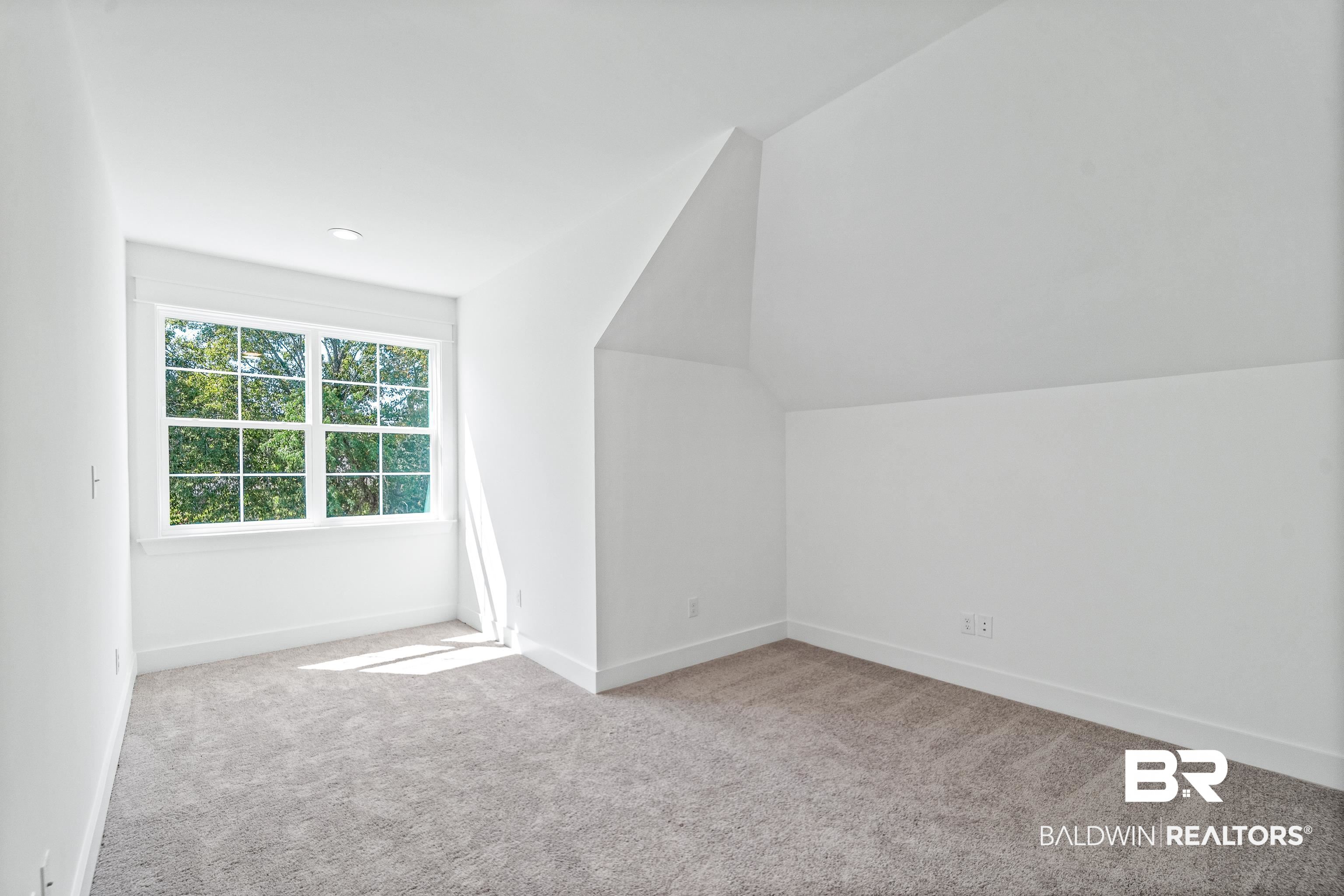 25927 Capra Court Daphne, AL 36526 - Photo 23 of 37 Bonus room featuring light carpet and vaulted ceiling