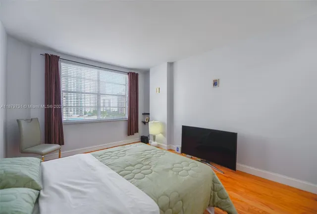 a bedroom with a bed and a chair