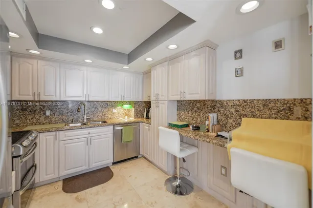 a kitchen with a sink stainless steel appliances and cabinets