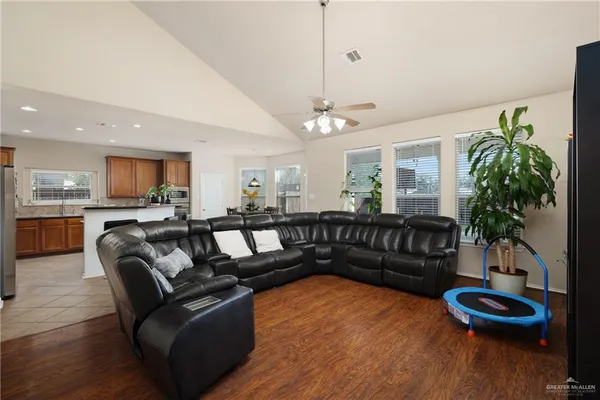 a living room with furniture and a wooden floor