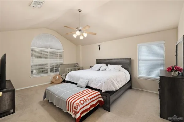 a bedroom with two beds and a chandelier