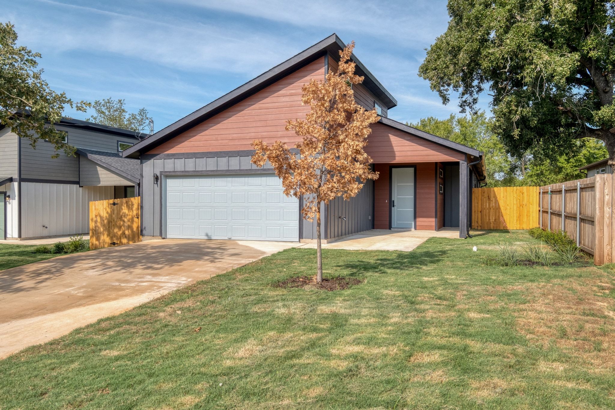 202 Washington Street Elgin, TX 78621 - Photo 2 of 26 View of front of property featuring driveway, board and batten siding, and a garage