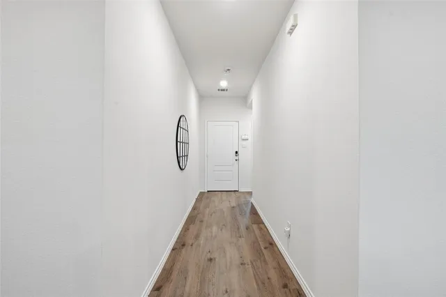 a living room with furniture kitchen view and a potted plant