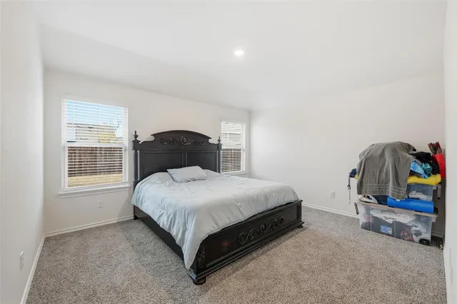 a bedroom with a bed and a television