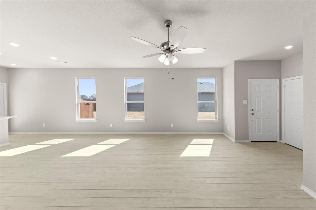 8224 Kingfisher Road Pilot Point, TX 76258 - Photo 13 of 27 a view of an empty room with window and chandelier fan