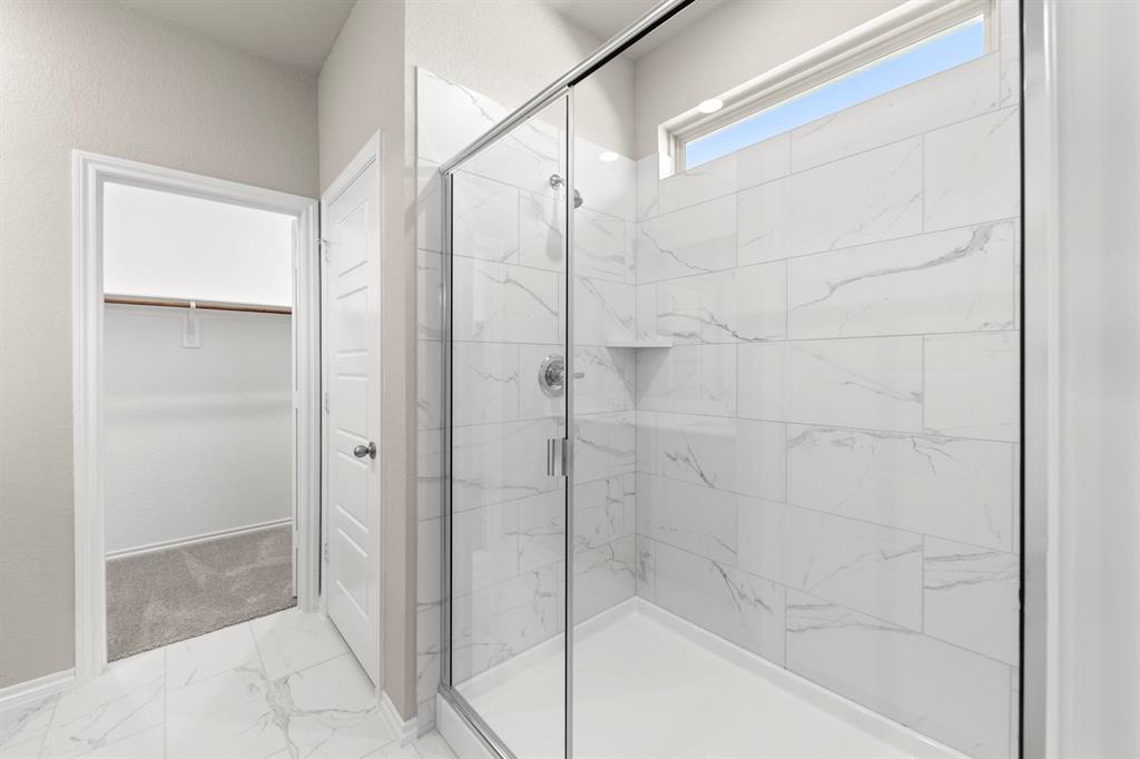 8224 Kingfisher Road Pilot Point, TX 76258 - Photo 21 of 27 a bathroom with a shower and a glass door
