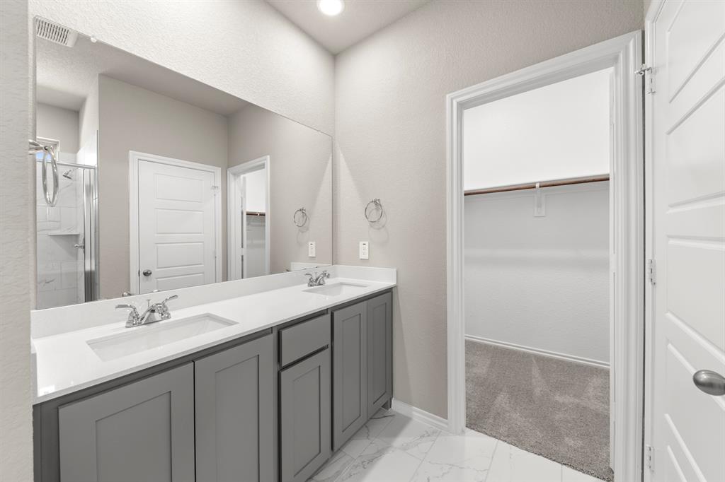 8224 Kingfisher Road Pilot Point, TX 76258 - Photo 22 of 27 a bathroom with a double vanity sink and mirror