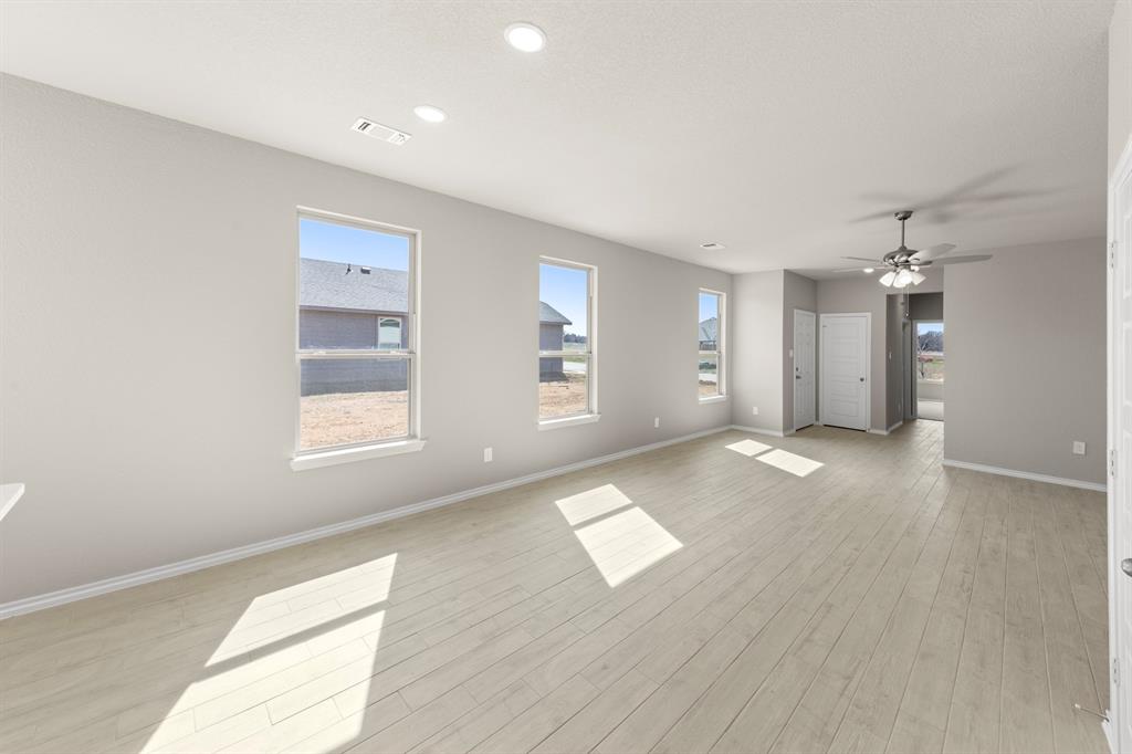 8224 Kingfisher Road Pilot Point, TX 76258 - Photo 9 of 27 wooden floor in an empty room with a window