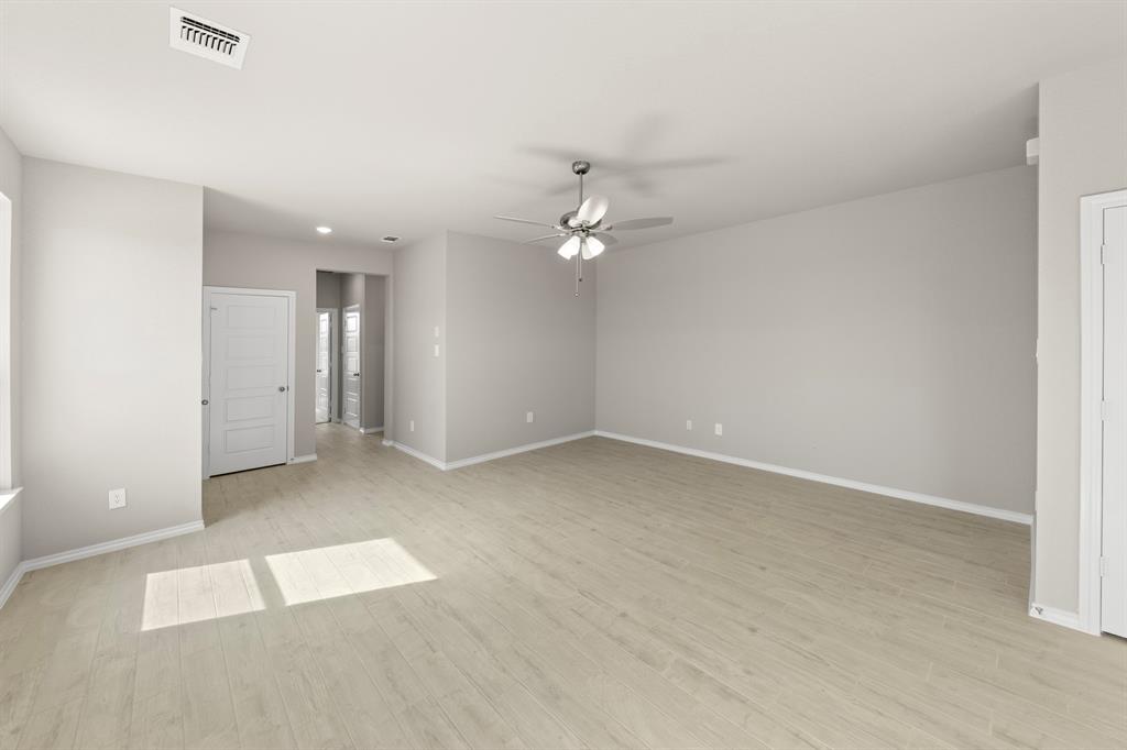 8224 Kingfisher Road Pilot Point, TX 76258 - Photo 10 of 27 wooden floor in an empty room with a window