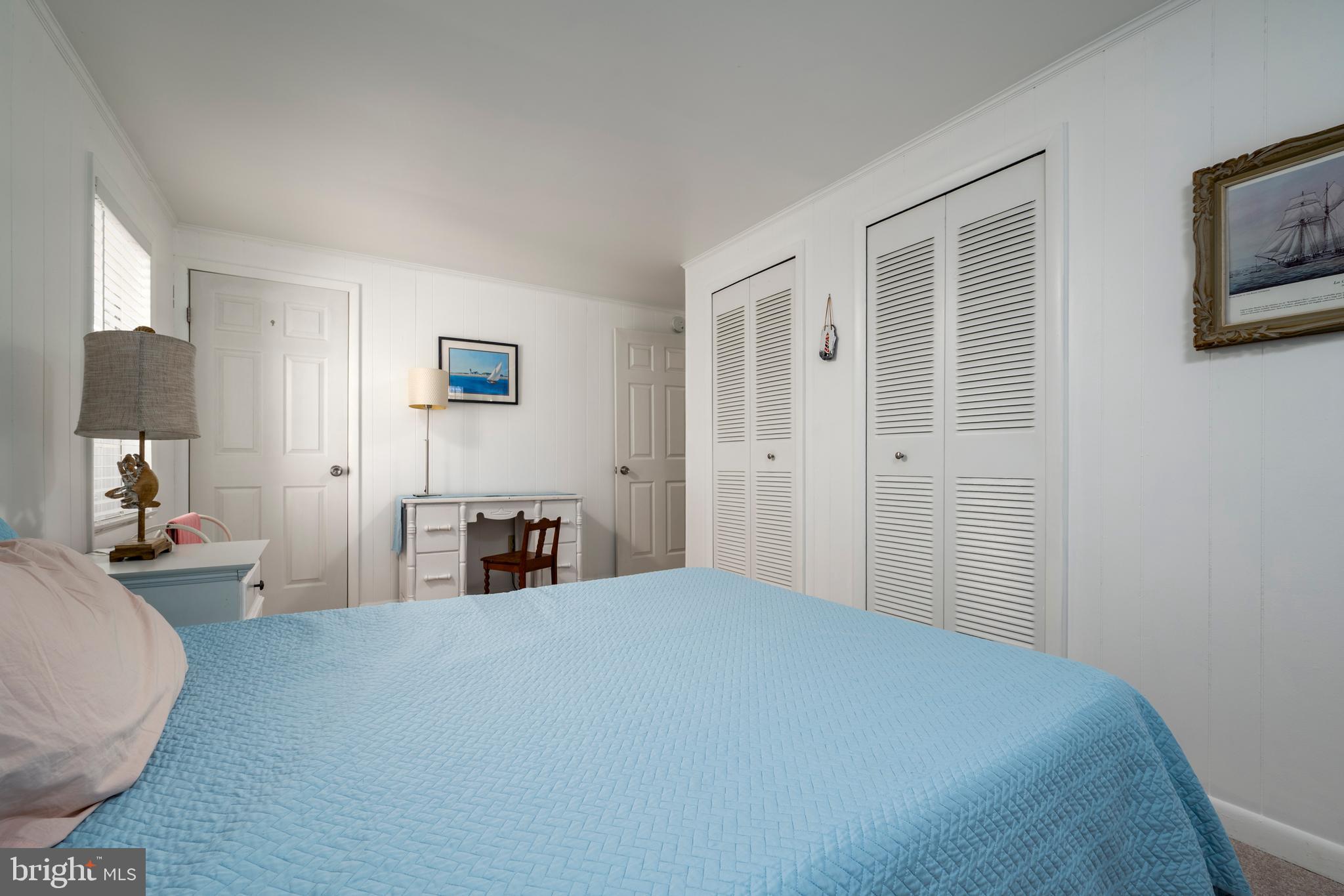 69 Windjammer Road Ocean Pines, MD 21811 - Photo 16 of 53 a bedroom with a bed and a large mirror