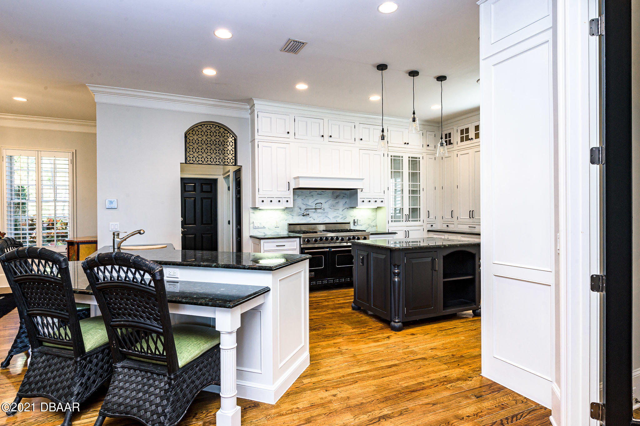 300 Riverside Drive Ormond Beach, FL 32176 - Photo 12 of 72 a kitchen with stainless steel appliances kitchen island granite countertop a refrigerator and a stove top oven