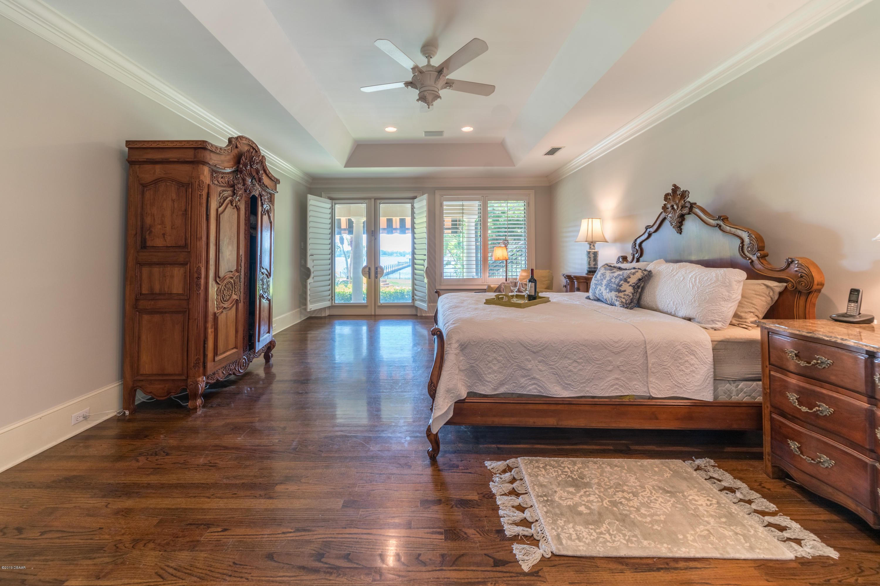 300 Riverside Drive Ormond Beach, FL 32176 - Photo 17 of 72 a bed room with a bed and a chandelier