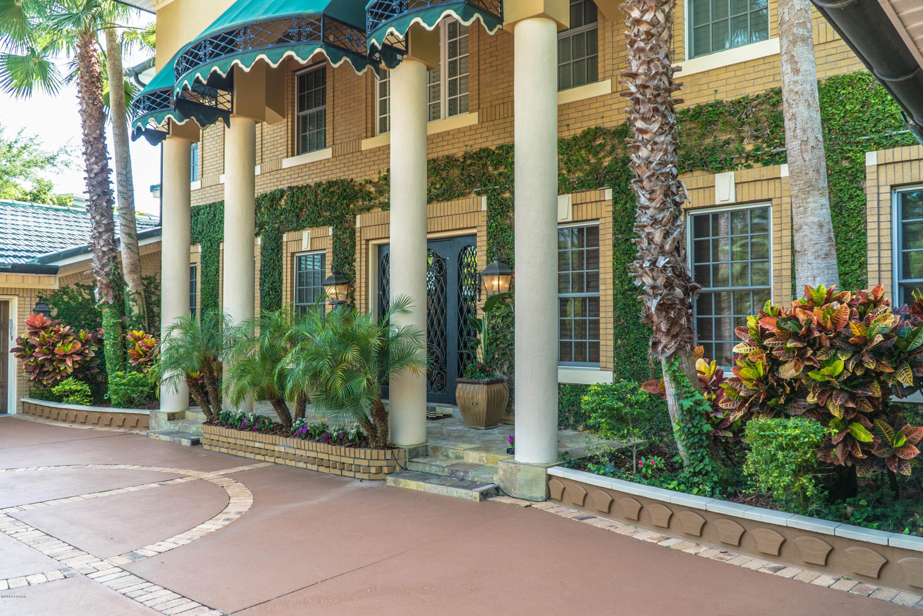 300 Riverside Drive Ormond Beach, FL 32176 - Photo 2 of 72 a view of a building with a garden