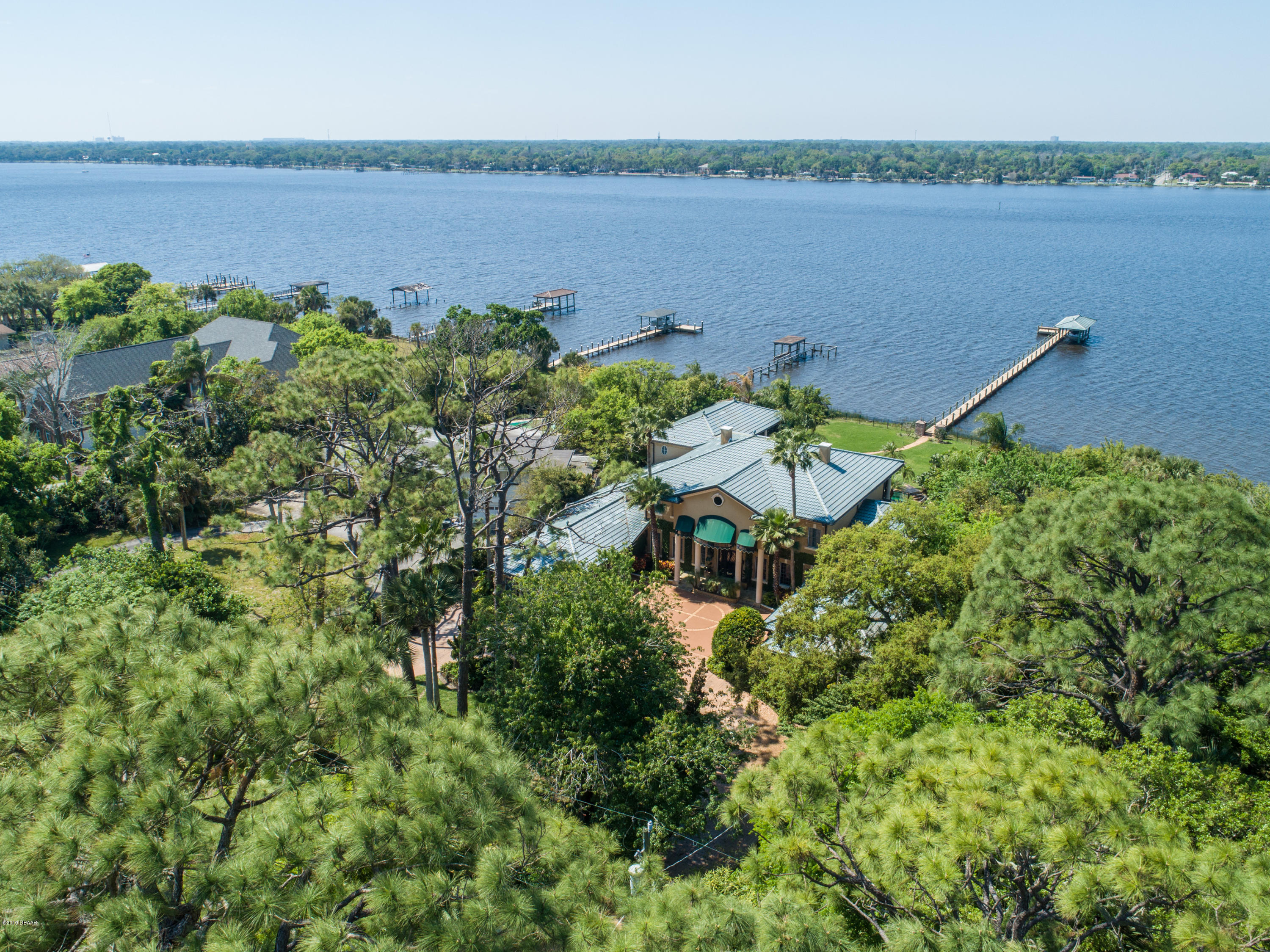 300 Riverside Drive Ormond Beach, FL 32176 - Photo 53 of 72 a aerial view of a houses with a lake view