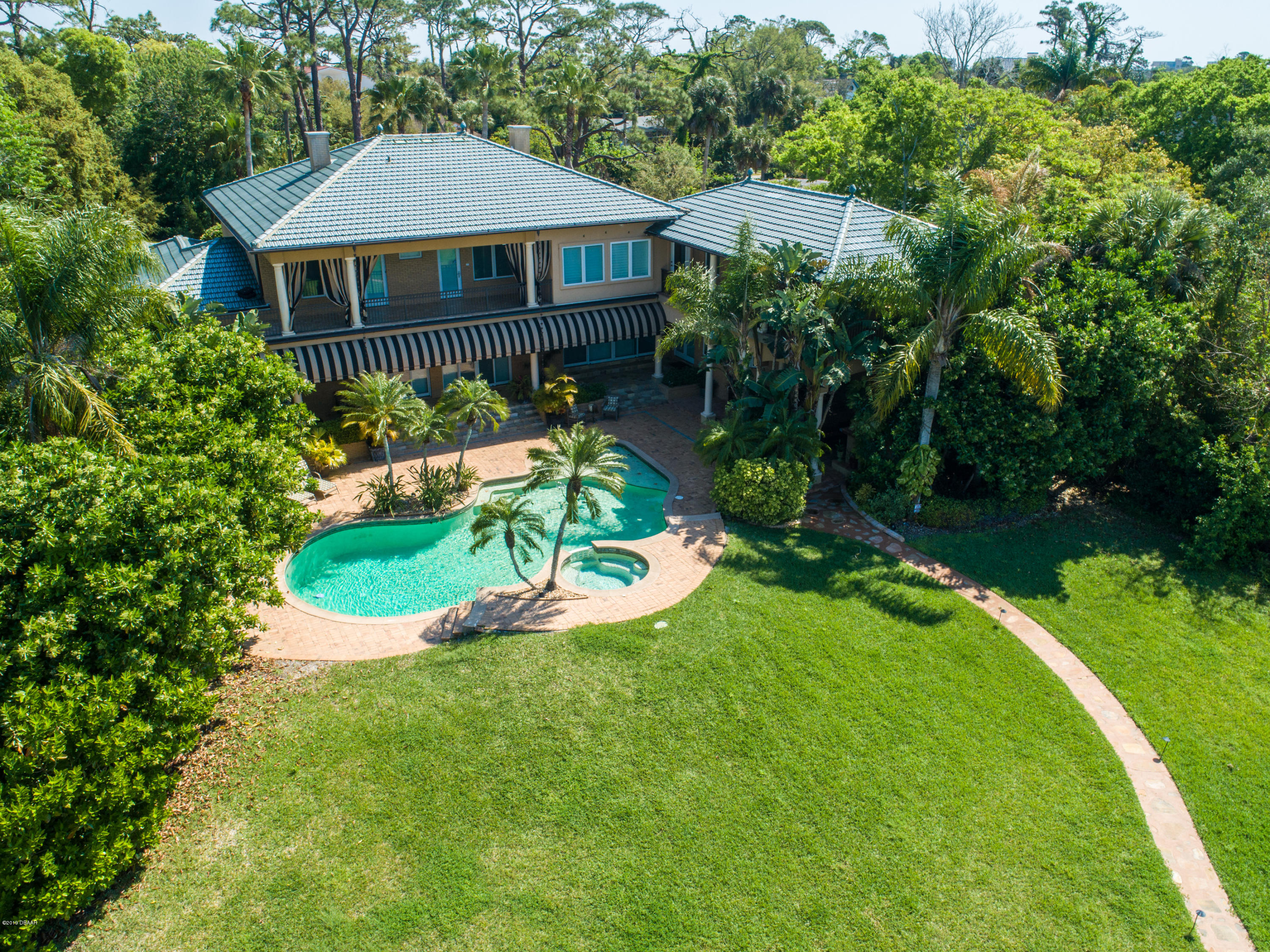 300 Riverside Drive Ormond Beach, FL 32176 - Photo 54 of 72 a front view of a house with a yard table and chairs