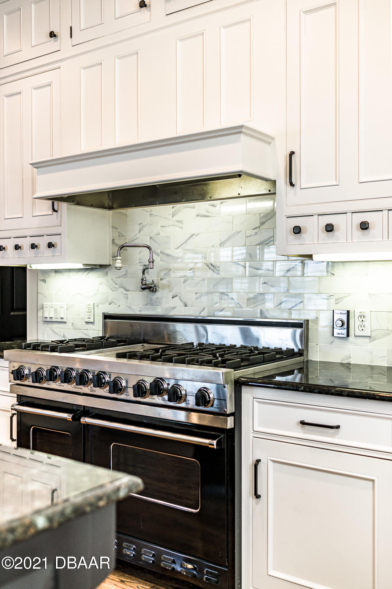 300 Riverside Drive Ormond Beach, FL 32176 - Photo 10 of 72 a stove top oven sitting inside of a kitchen