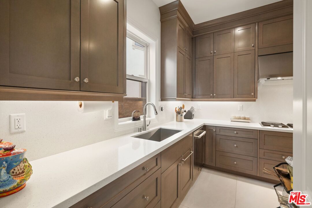 20244 Albion Way Porter Ranch, CA 91326 - Photo 11 of 47 a kitchen with a sink cabinets and appliances