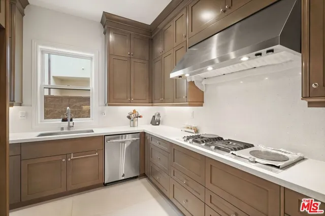 a kitchen with a sink stove and cabinets
