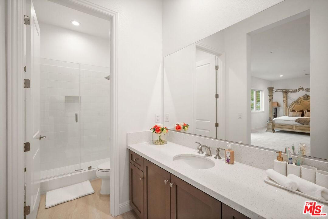 20244 Albion Way Porter Ranch, CA 91326 - Photo 14 of 47 a bathroom with a sink a toilet and shower