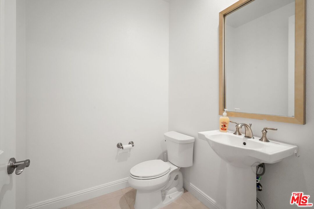 20244 Albion Way Porter Ranch, CA 91326 - Photo 17 of 47 a bathroom with a sink toilet and a mirror