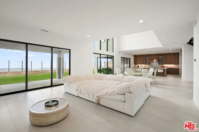 a spacious bedroom with a bed and a large window