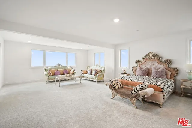 a bedroom with two beds and a couch