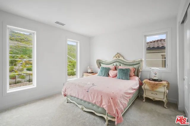 a bedroom with a bed and a view of kitchen