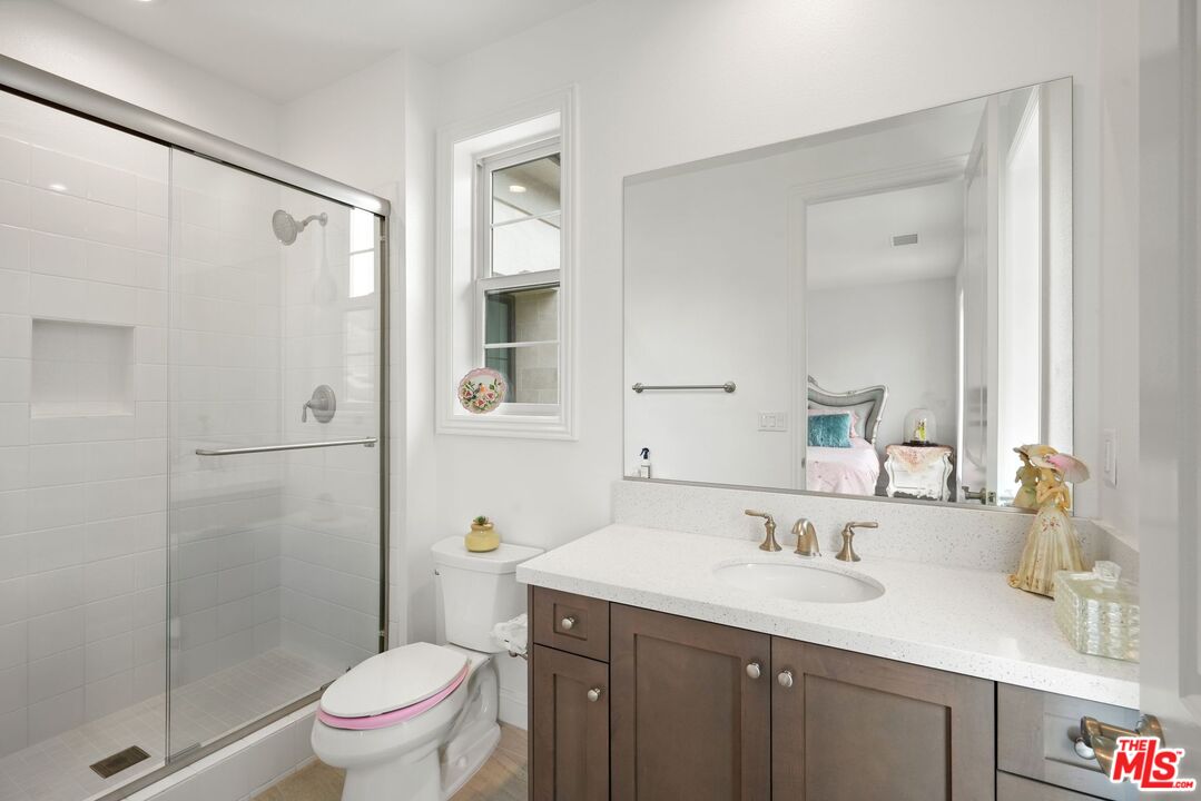 20244 Albion Way Porter Ranch, CA 91326 - Photo 30 of 47 a bathroom with a granite countertop sink toilet and shower