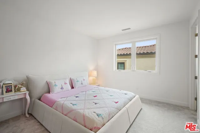 a bedroom with a bed and a cabinets