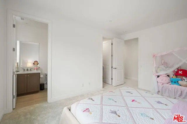 a view of a bedroom with wooden floor