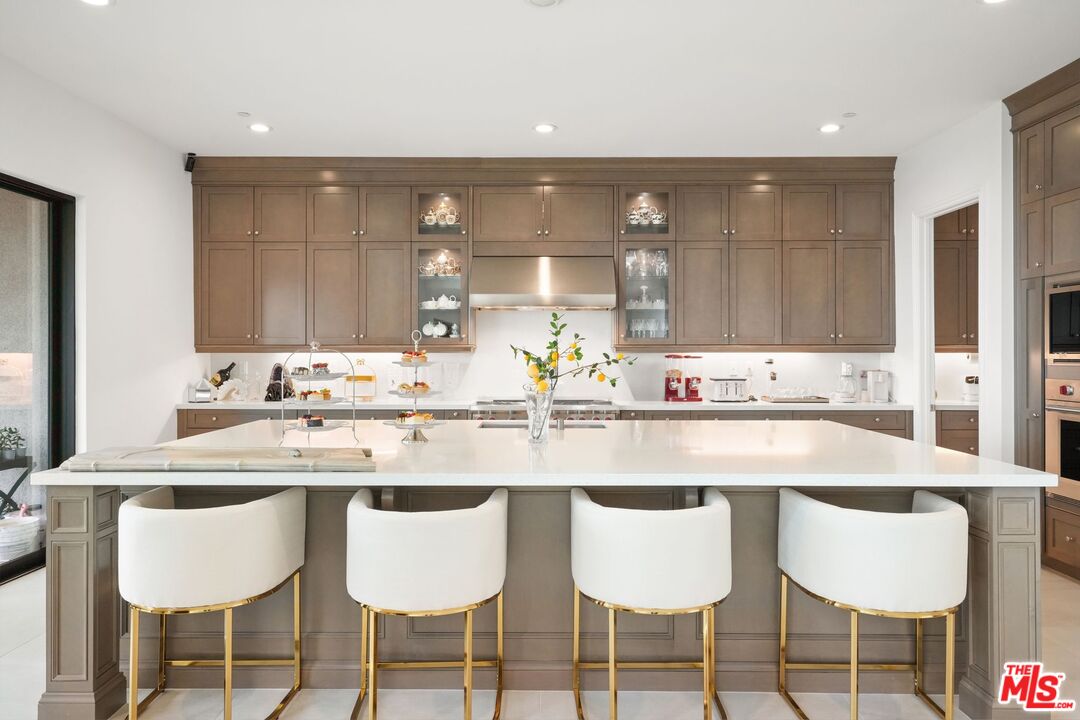 20244 Albion Way Porter Ranch, CA 91326 - Photo 7 of 47 a kitchen with a dining table and chairs