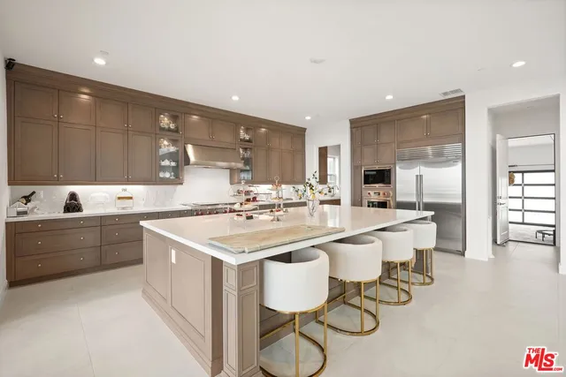 a large kitchen with a table and chairs in it