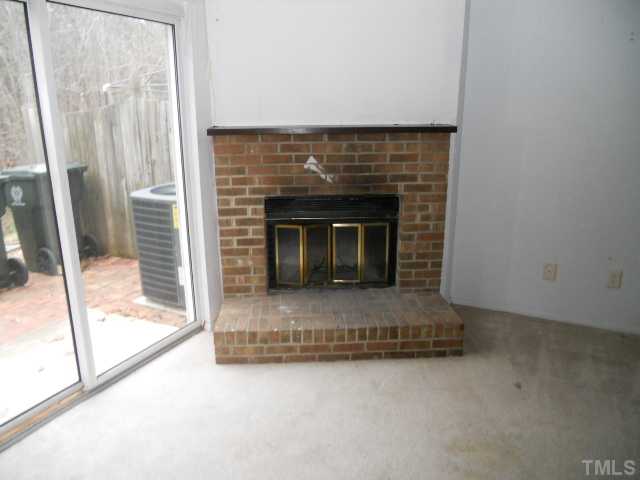 7748 Sandra Lane Raleigh, NC 27615 - Photo 6 of 8 a living room with a fireplace