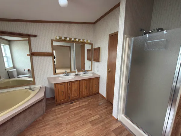 a bathroom with a tub sink and mirror