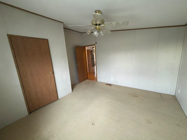 a view of a hallway with a chandelier fan