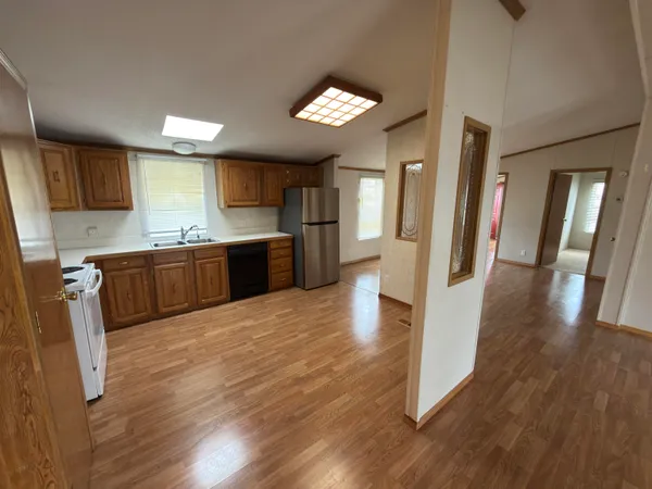 a large kitchen with a wooden floor and cabinets