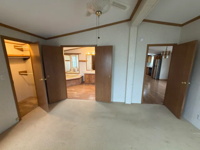 a view of a hallway with wooden cabinet