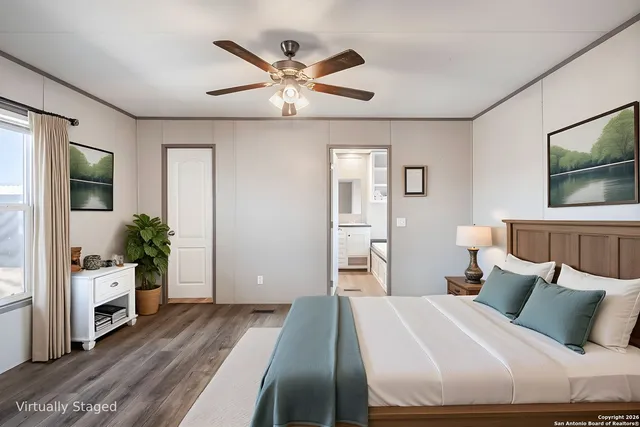 an empty room with wooden floor chandelier fan and windows