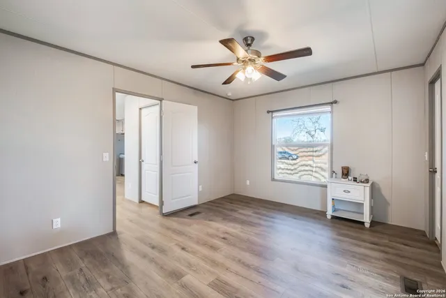 a bathroom with a granite countertop toilet sink and mirror