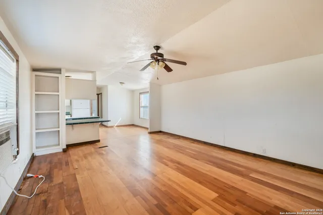 a large kitchen with cabinets wooden floor and stainless steel appliances