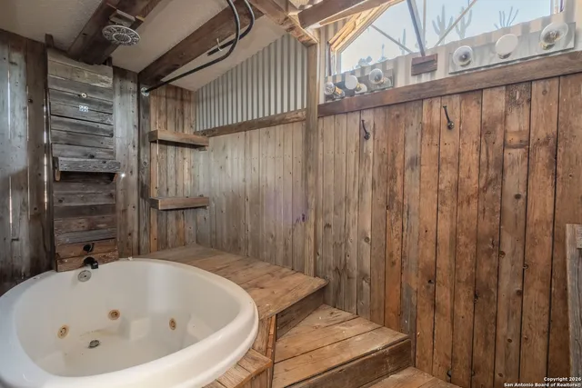 an empty room with wooden floor and a ceiling fan