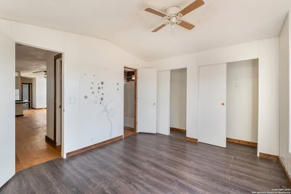 a view of a livingroom with hardwood floor and cabinet