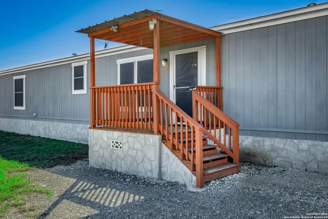 a view of a wooden house with a yard