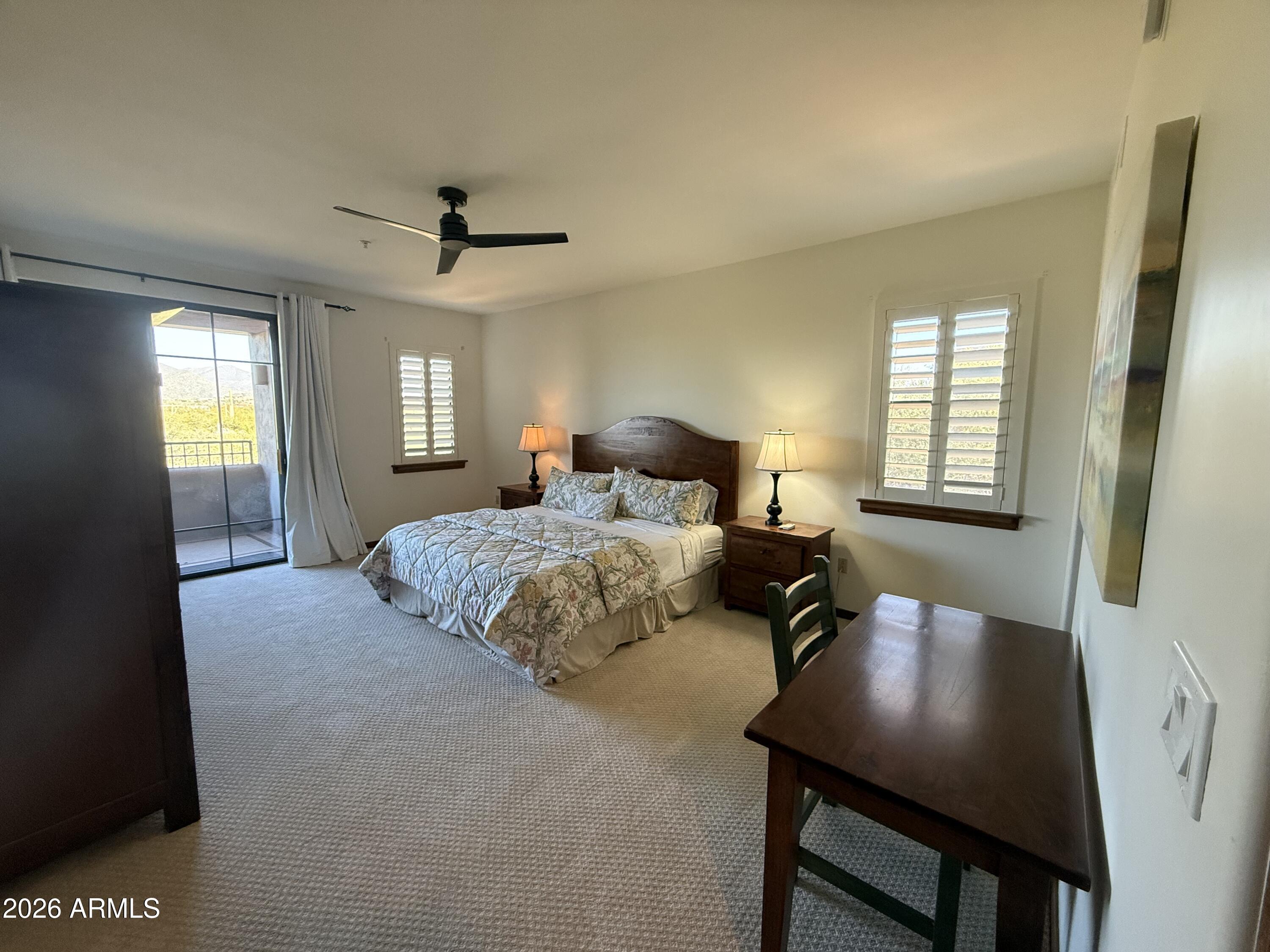 36601 North Mule Train Road, Unit D18 Carefree, AZ 85377 - Photo 20 of 57 a bedroom with a bed mirror and window